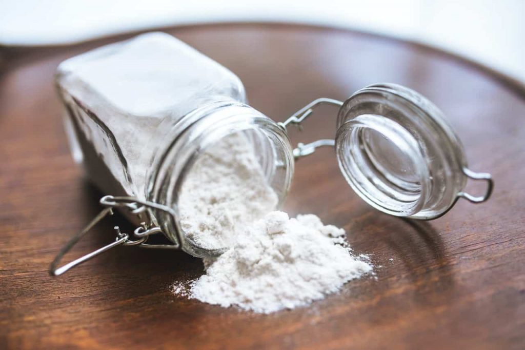 baking soda spilling out of a mason jar