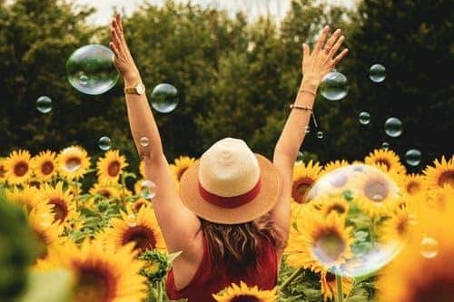 Woman enjoying a sunny day in a field of sunflowers