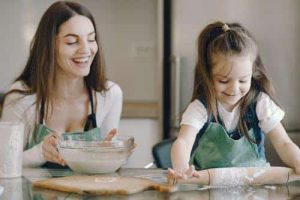 Mother and daughter baking together