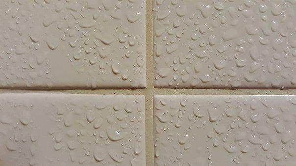 Close up of grout and wet tiles