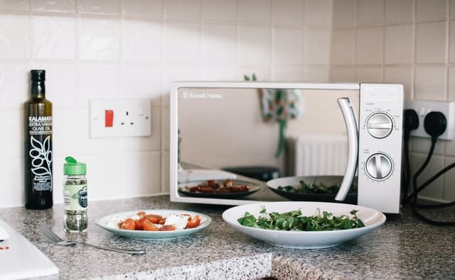 Microwave oven sitting on a kitchen benchtop