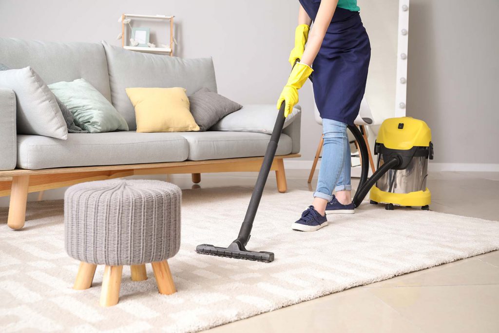 House cleaner in Melbourne vacuuming a rug